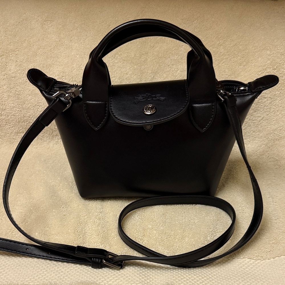 Elegant Longchamp Le Pliage mini pouch with shoulder strap.